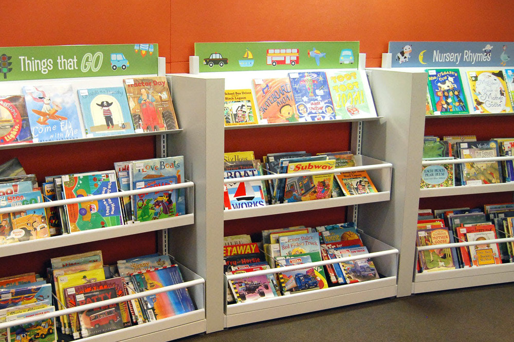 Photo of children's books on low shelves at the library