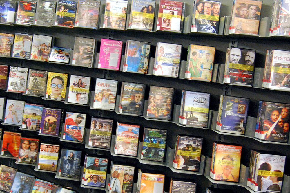 Photo of family DVDs on shelves at the library
