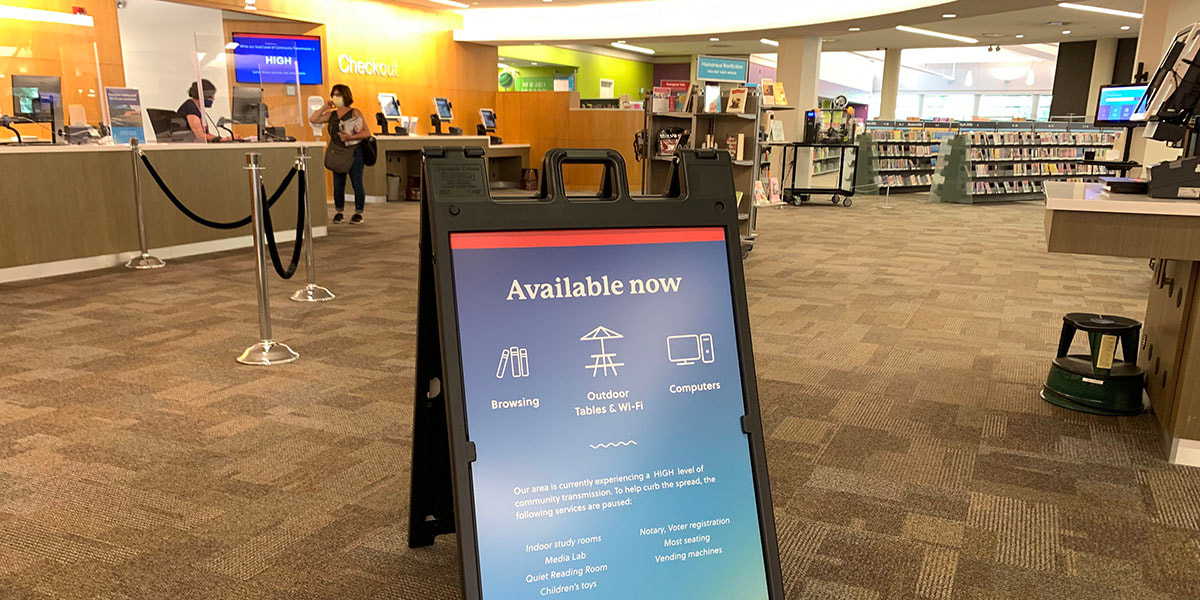Picture of library lobby sign showing available services including browsing and outdoor seating/Wi-Fi